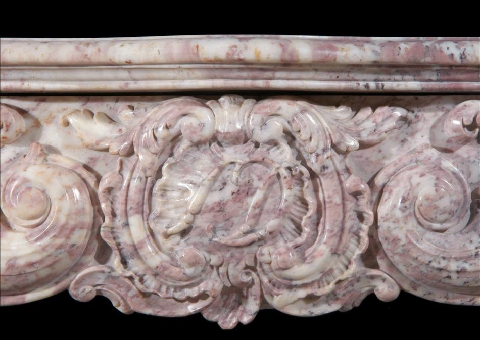An 18th century French Louis XV Rose Boreal marble fireplace