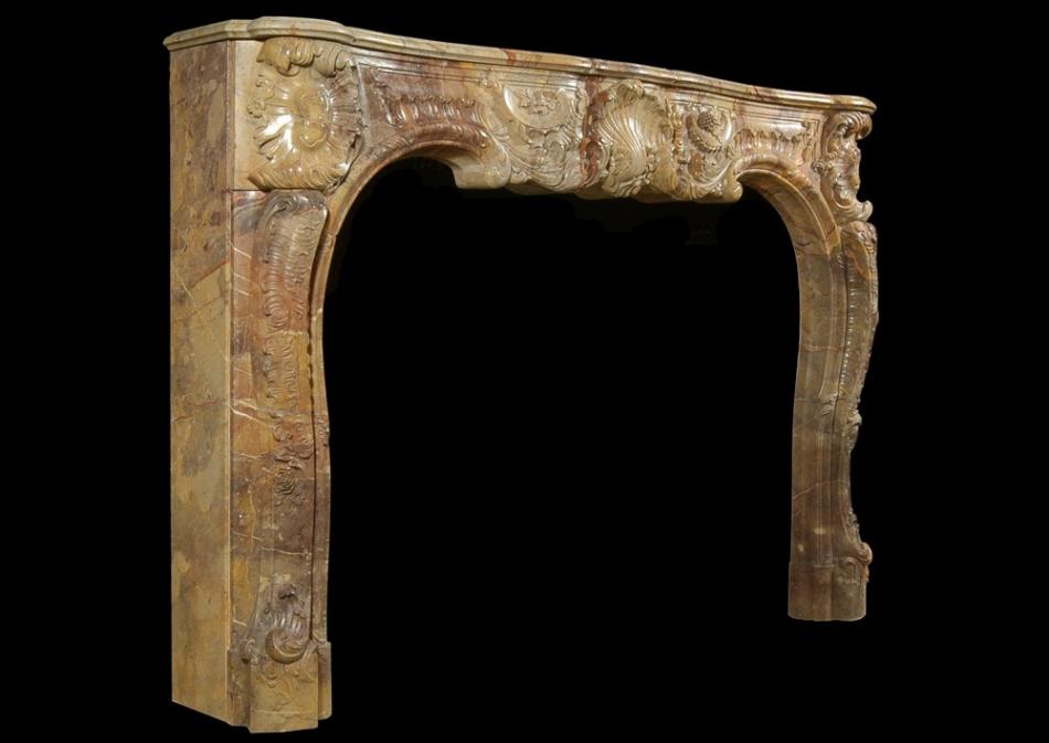 A superb quality French Louis XV style carved Sarrancolin marble fireplace