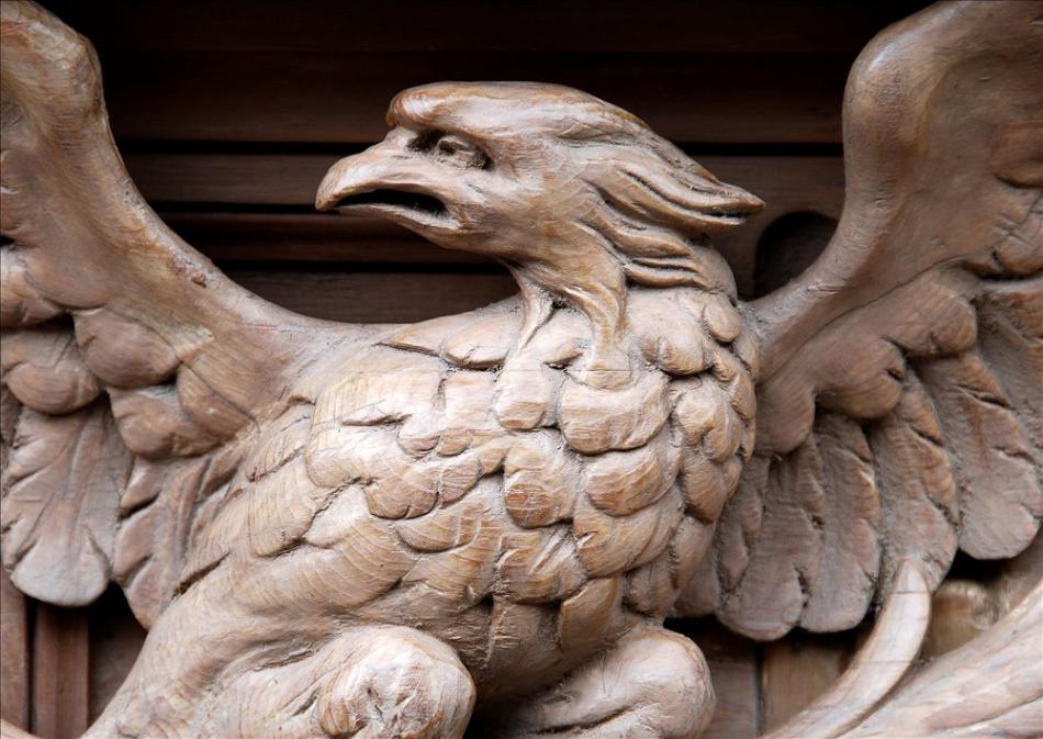 A Neo-Classical English pine fireplace with carved eagle to frieze