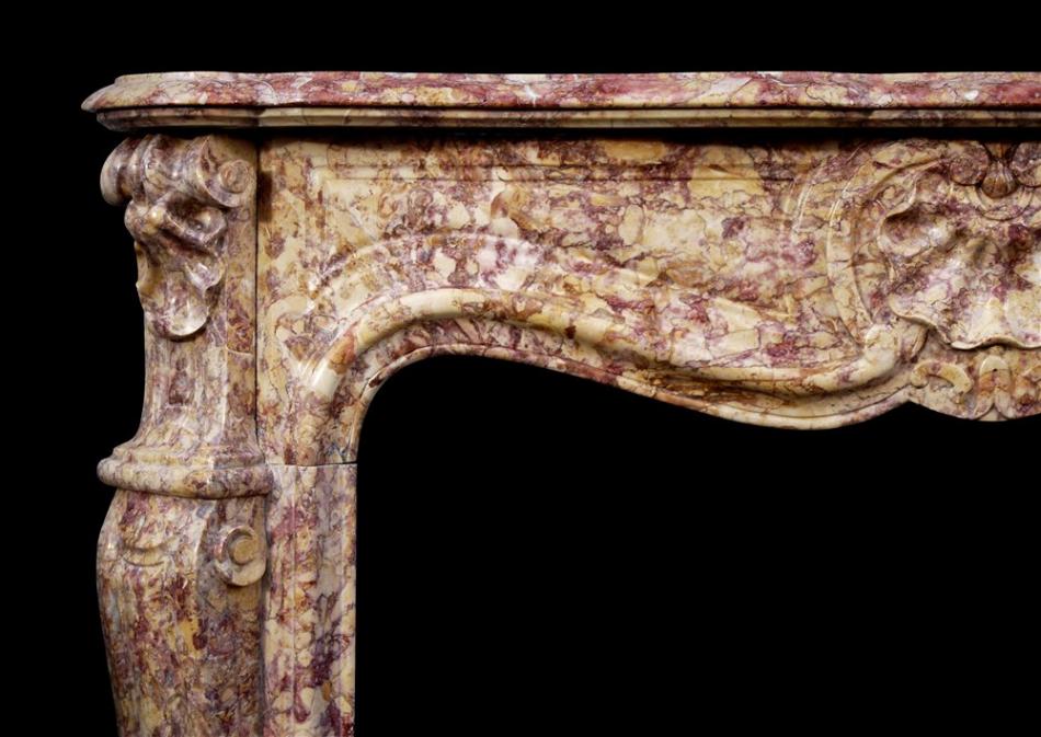 A French Louis XV style fireplace in Spanish Brocatelle marble