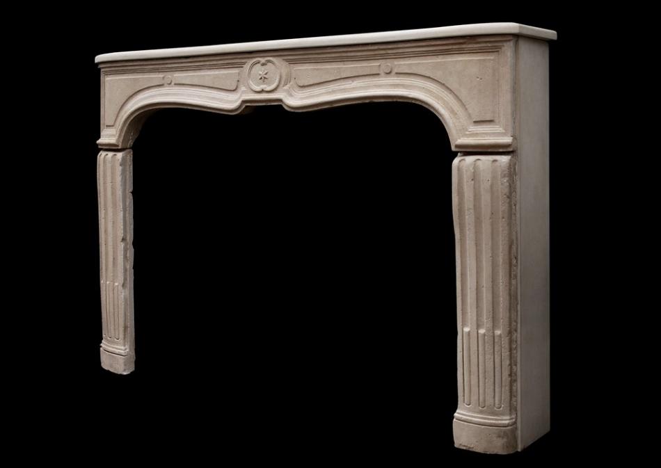 An unusual 18th century French limestone fireplace