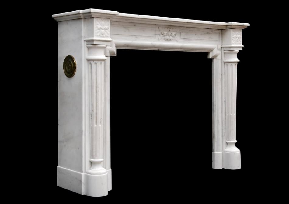 A French Louis XVI style fireplace in Statuary marble