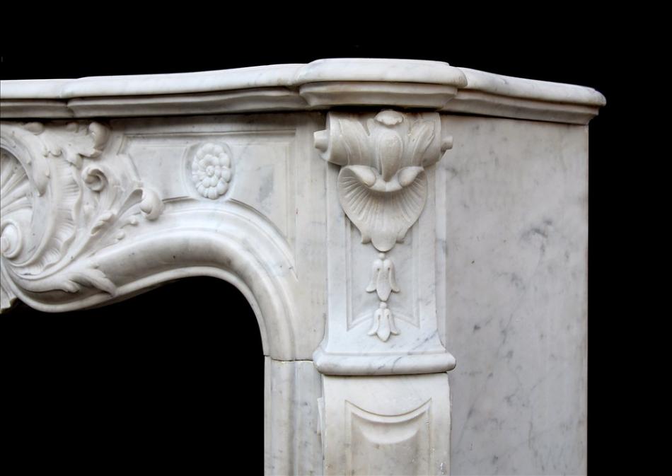 A French Carrara marble Louis XV style fireplace