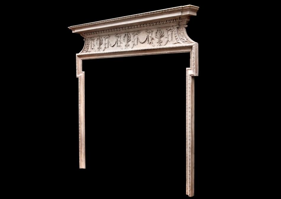 A delicate 18th century English pine fireplace