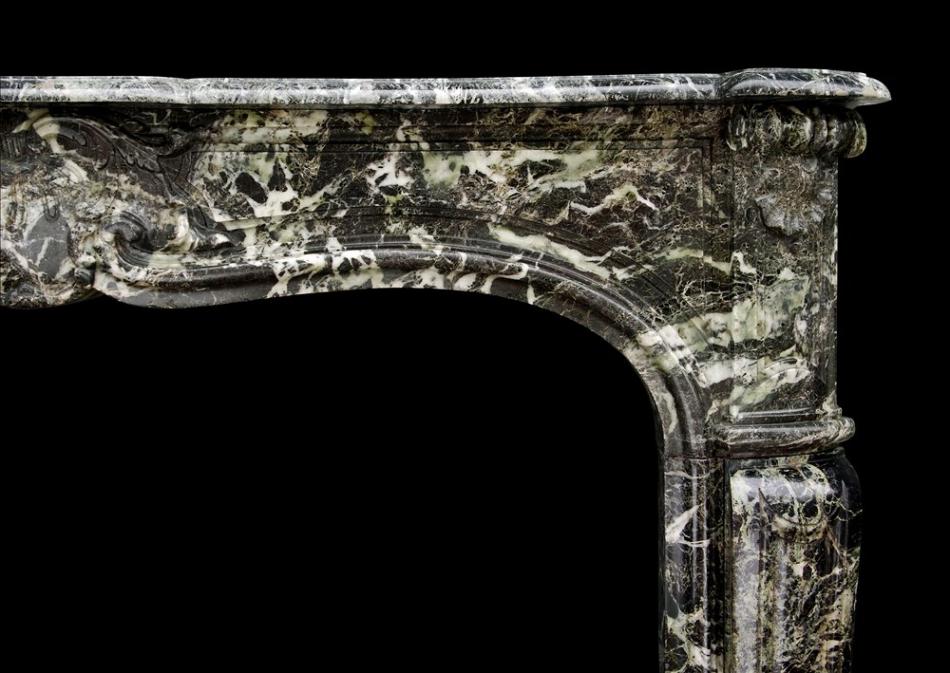 A French Louis XV style antique fireplace in Tinos green marble