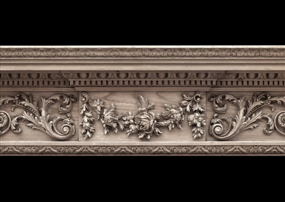 A Georgian style carved pine fireplace