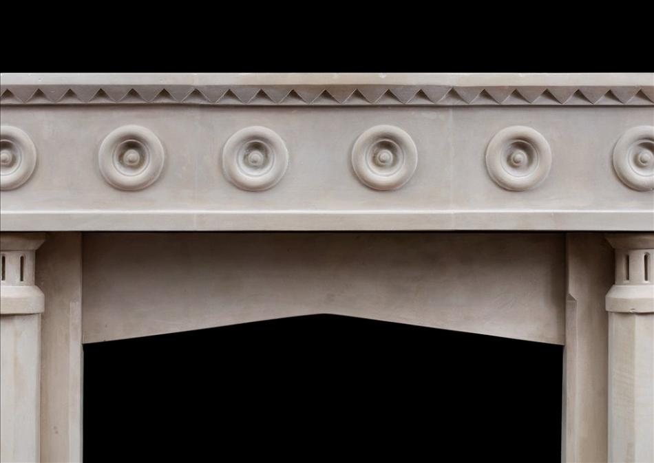 An English limestone fireplace with a gothic influence