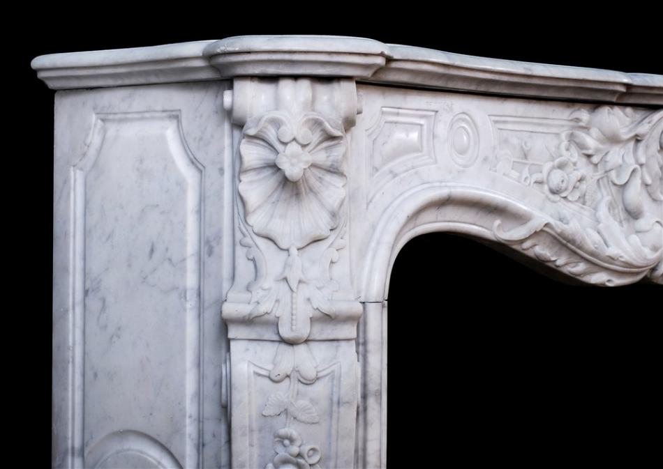 A fine quality carved French Louis XV Carrara fireplace