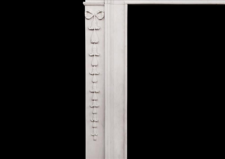 An attractive George III style white marble fireplace