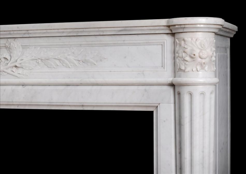 A 19th century French Louis XVI style mantel piece in light Carrara marble