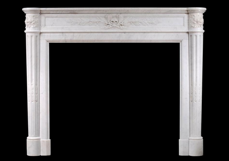 A 19th century French Louis XVI style mantel piece in light Carrara marble