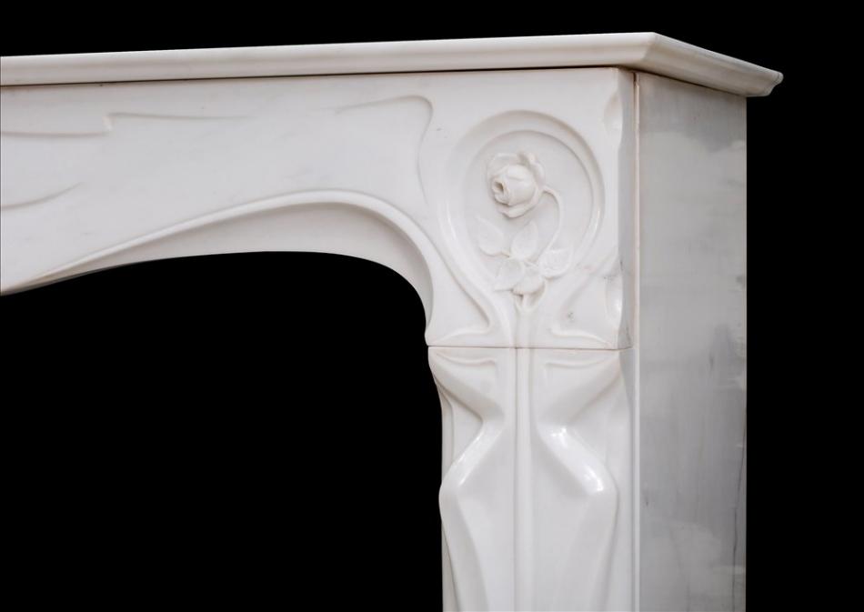 A refined French Art Nouveau white Statuary marble fireplace