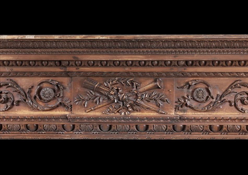 A late 18th century carved pine English fireplace