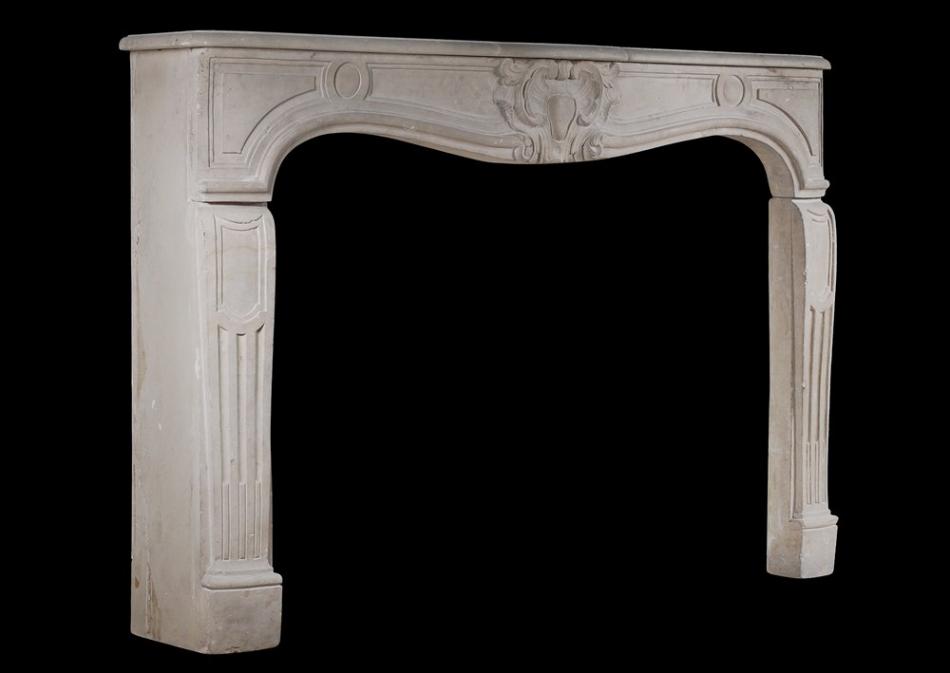 A 19th century French limestone chimneypiece in the Louis XV style
