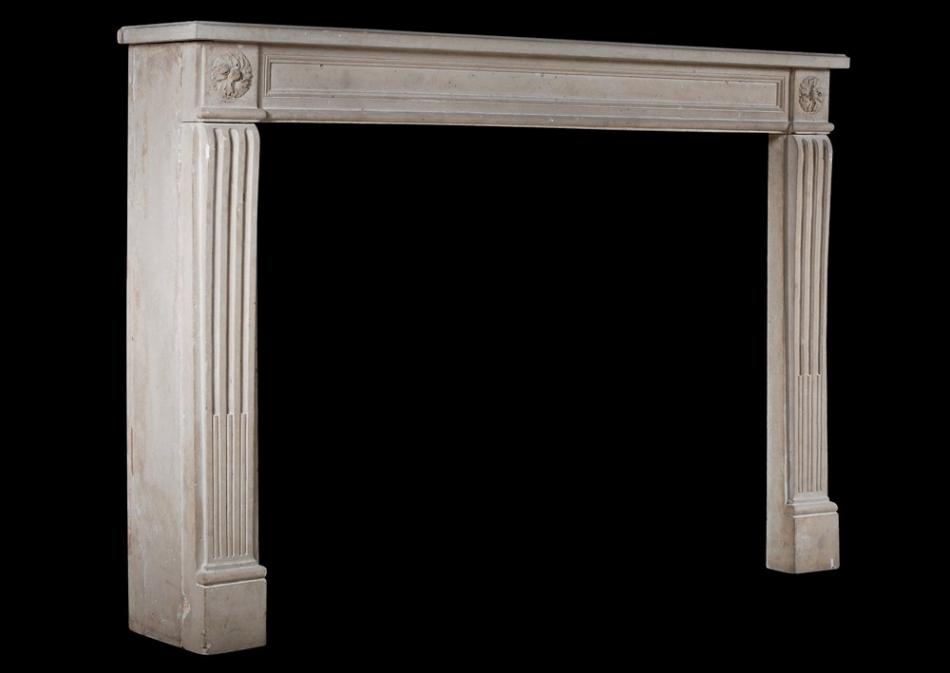 A 19th century French Louis XVI style stone fireplace
