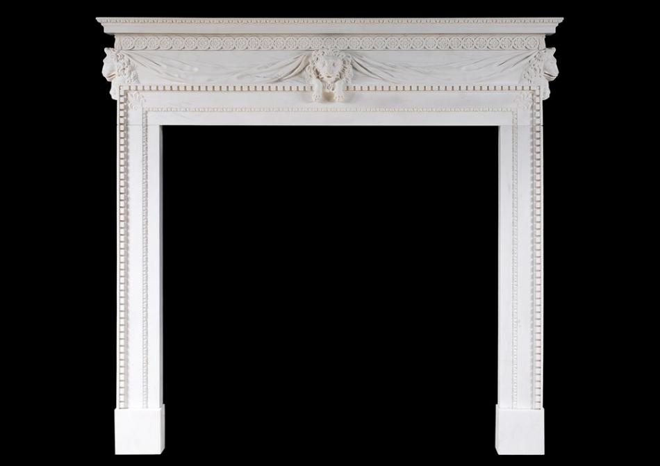 A white marble fireplace with carved lion's mask