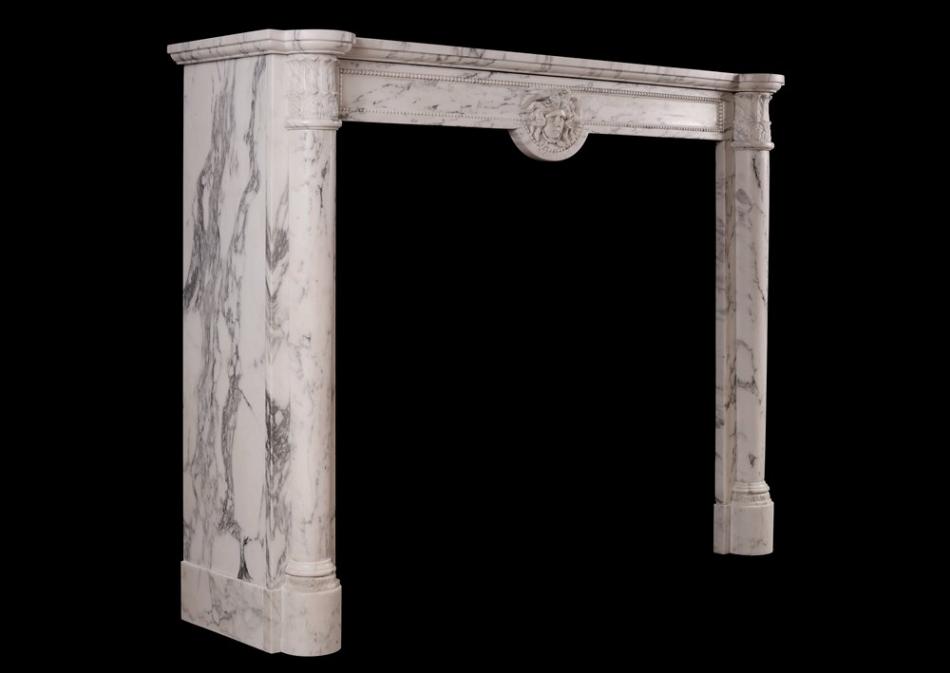 An antique French Louis XVI style fireplace in veined Statuary marble