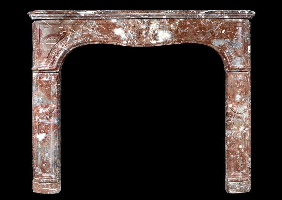 An 18th century French Louis XV fireplace in Languedoc marble