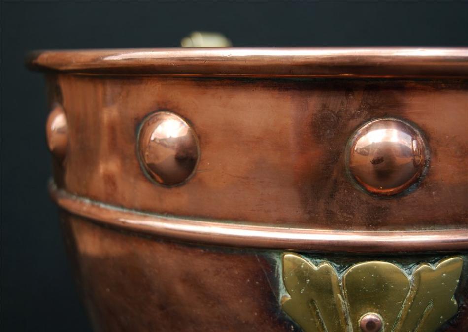 A small copper coal bucket with brass embellishments