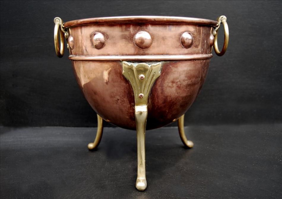 A small copper coal bucket with brass embellishments