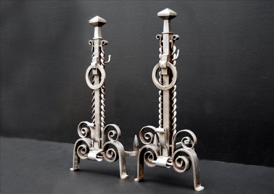 A pair of unusual 19th century english steel firedogs