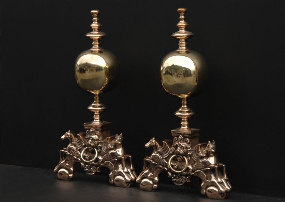 An impressive pair of brass firedogs
