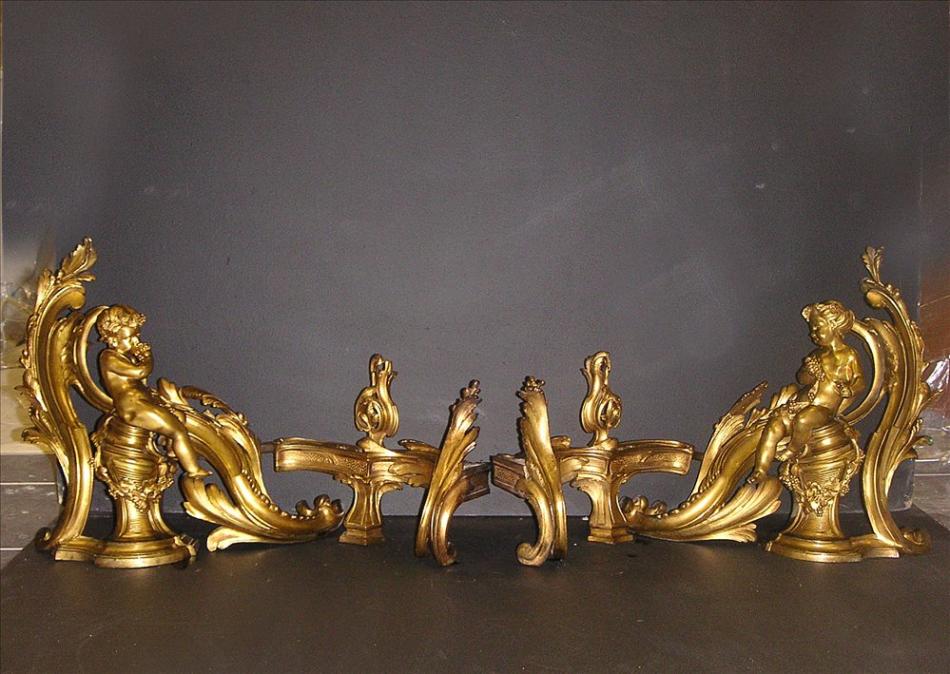 An impressive pair of 18th century Louis XV brass chenets