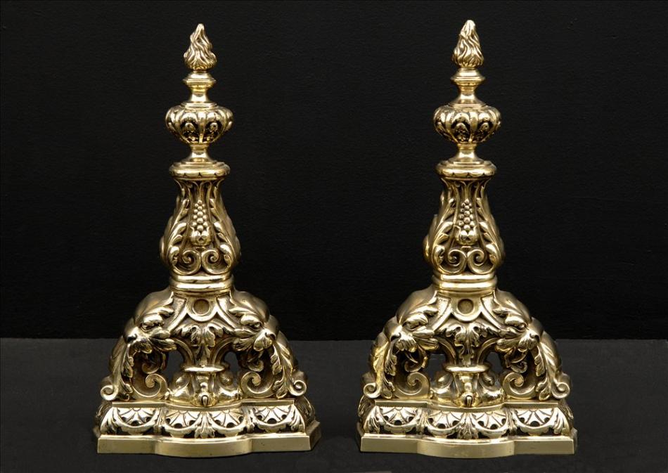 A pair of decorative brass firedogs