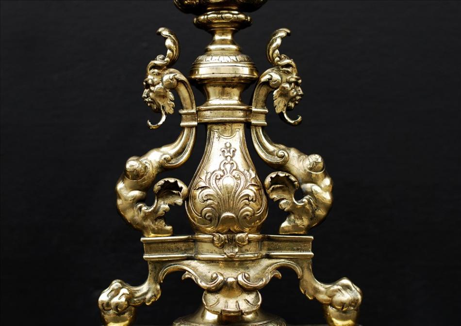 A decorative pair of English brass firedogs