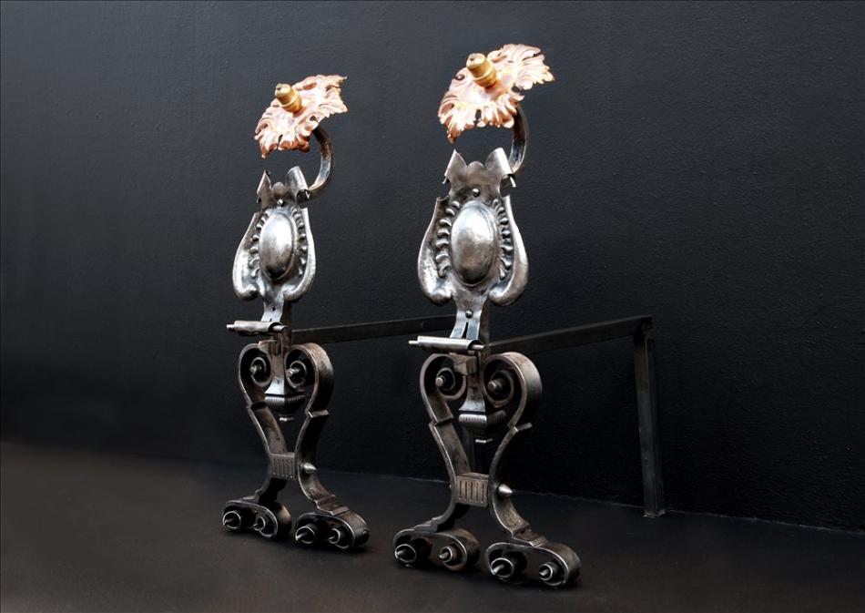 A large pair of Arts & Crafts firedogs with brass sunflower finials