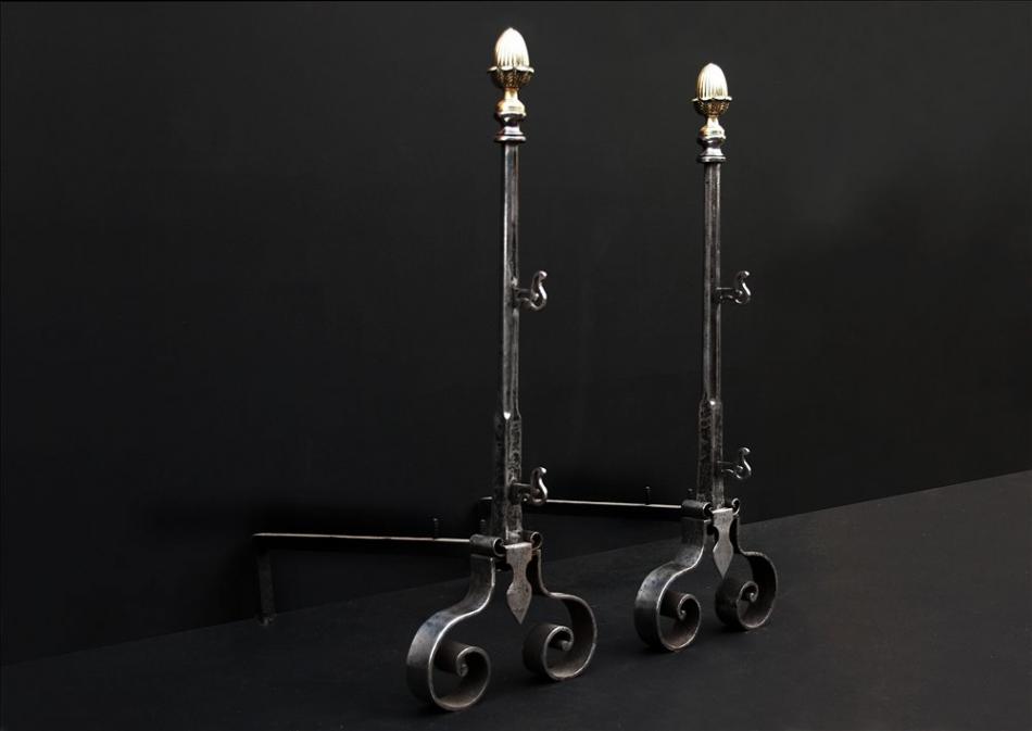 An elegant pair of english firedogs with brass acorn finials