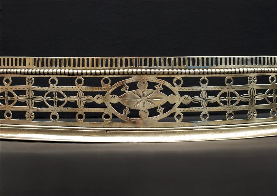 An 18th century engraved antique brass fender