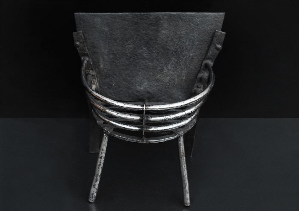 A small polished cast iron firebasket