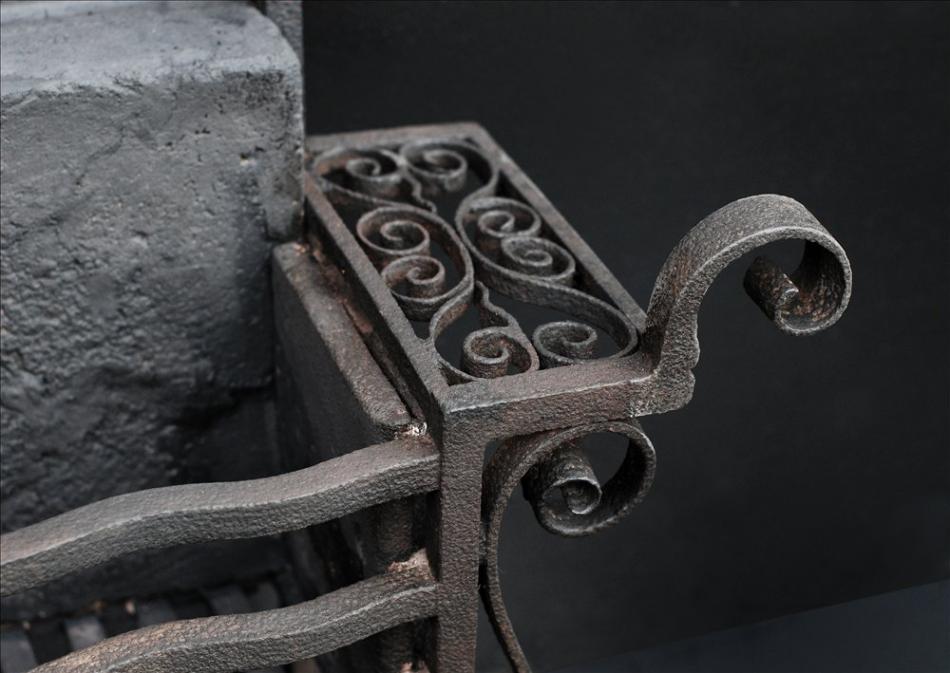 An unusual scrolled wrought iron firegrate