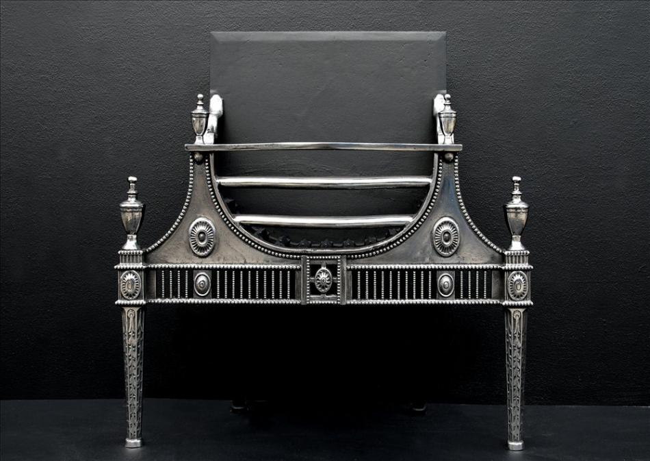 A Georgian style polished cast iron firebasket