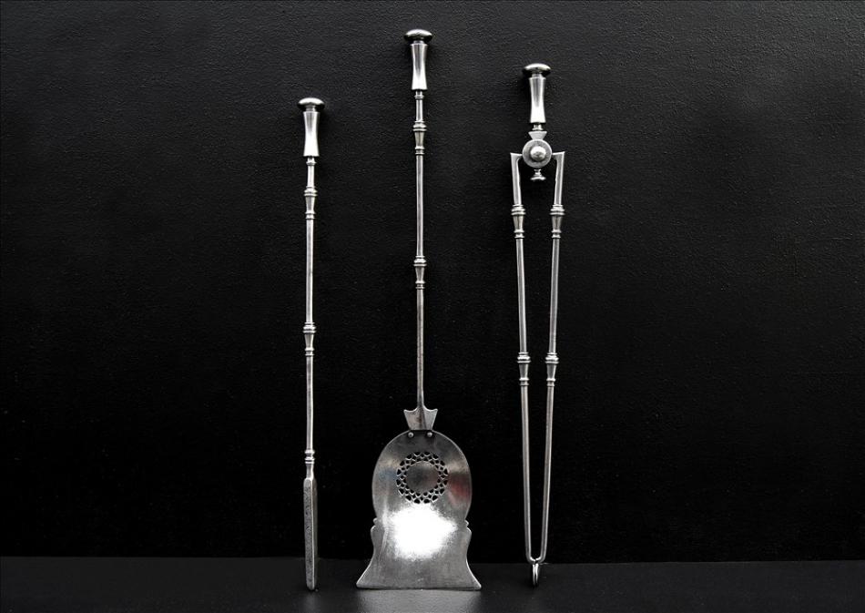 A set of 19th century pierced steel fire irons