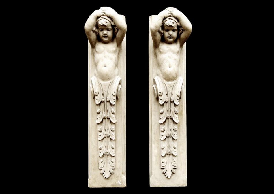 A pair of 19th century English glazed terracotta cherub figures
