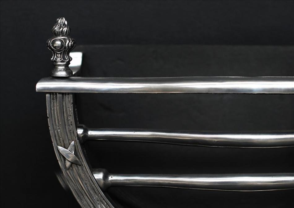 A elegant Regency style polished cast iron firegrate