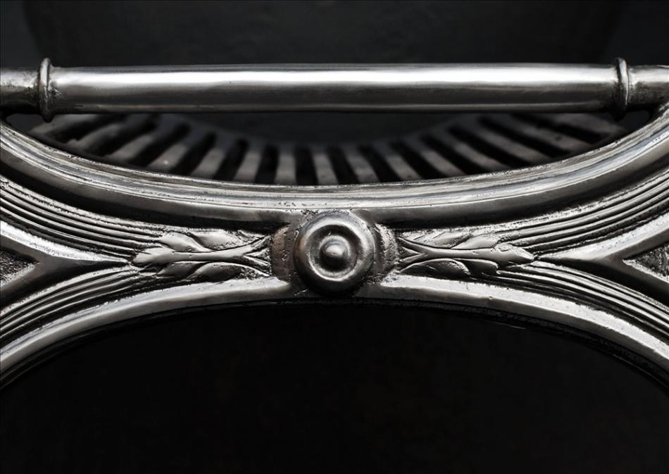 An elegant Regency style polished cast iron firegrate