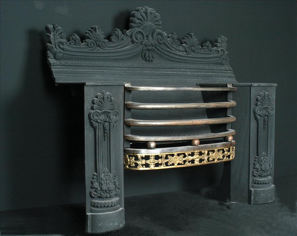 A 19th century English cast iron hob-grate with brass fret