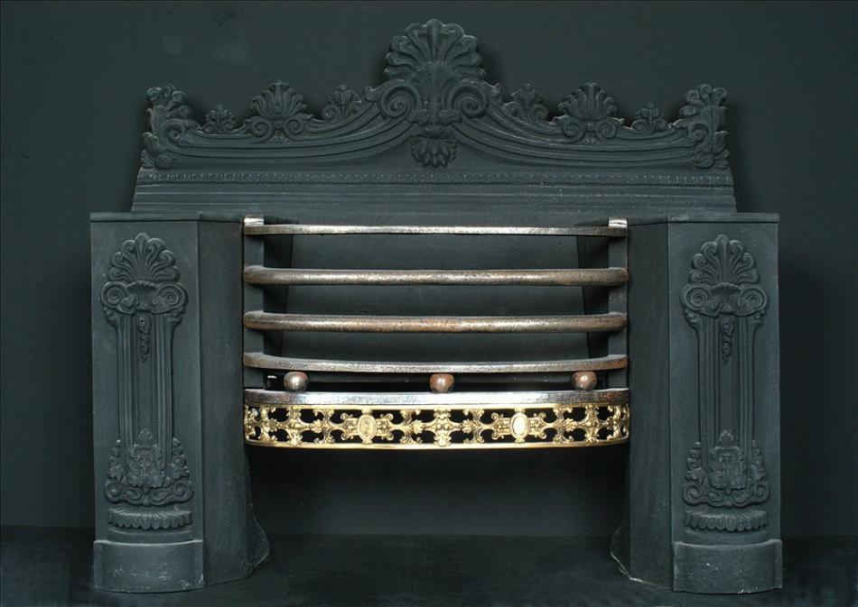 A 19th century English cast iron hob-grate with brass fret