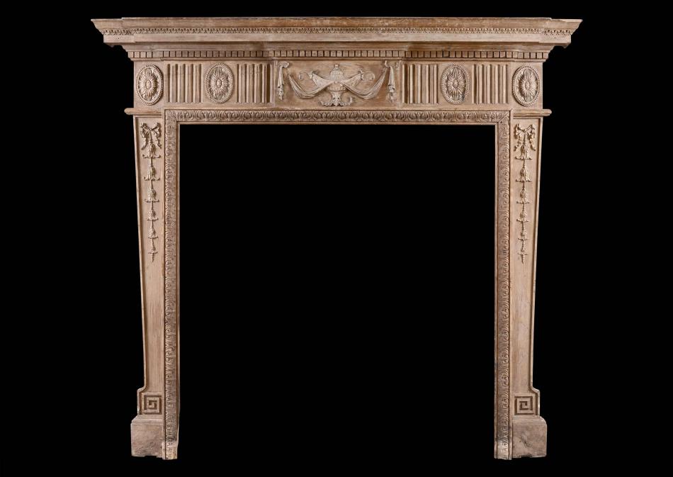 A Neo-Classical pine fireplace with carved urn