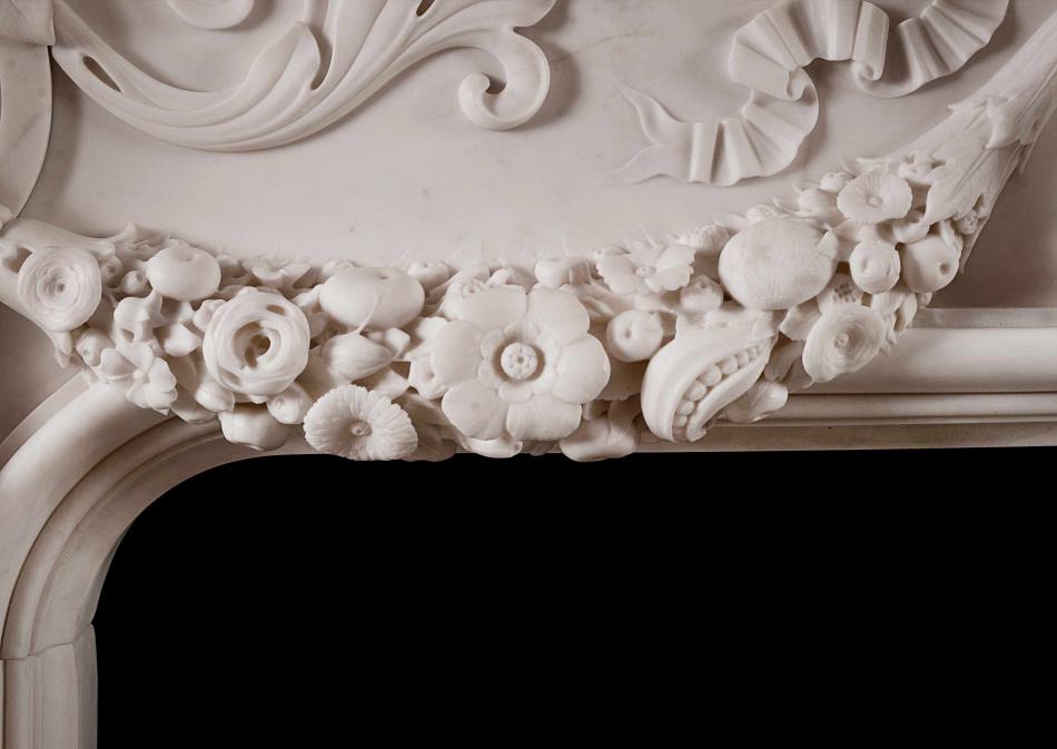 An ornately carved Italian Statuary marble fireplace