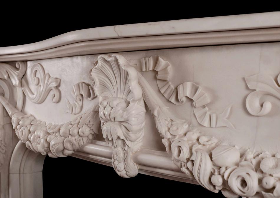 An ornately carved Italian Statuary marble fireplace