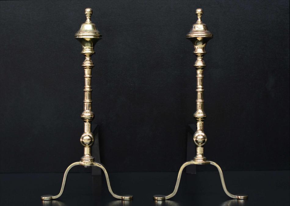 A pair of elegant brass firedogs