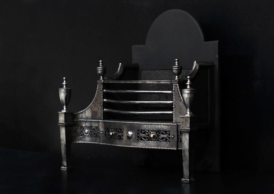 A George III style steel firegrate with pierced fret