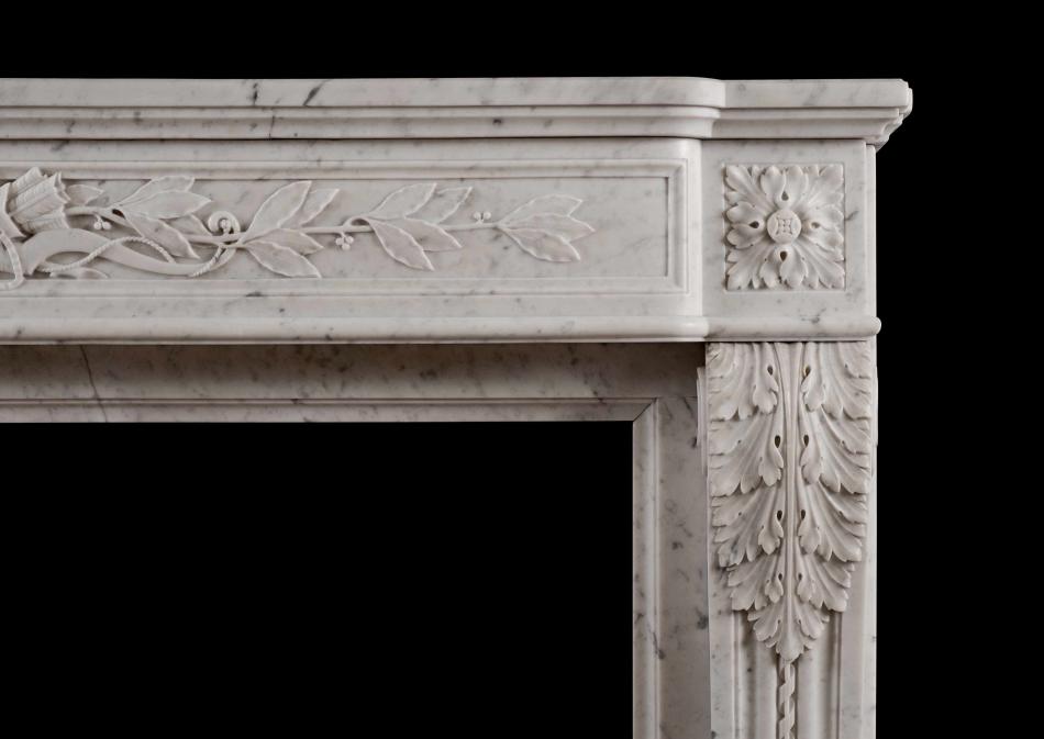 A Louis XVI style French antique fireplace in Carrara marble