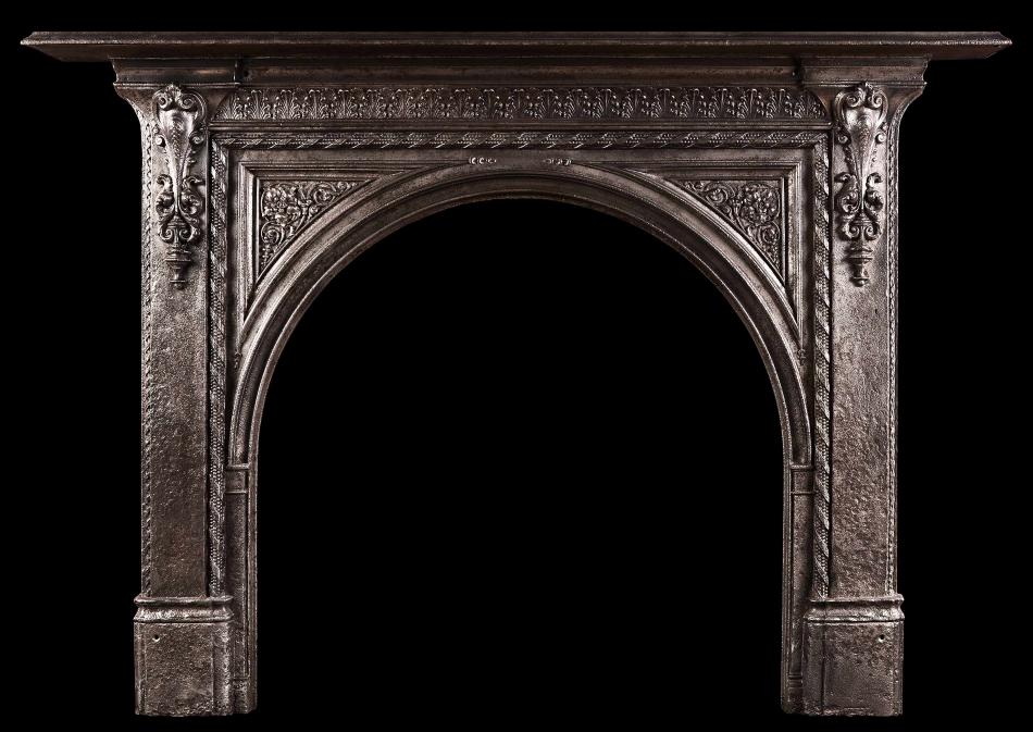 A 19th century iron fireplace with arched opening