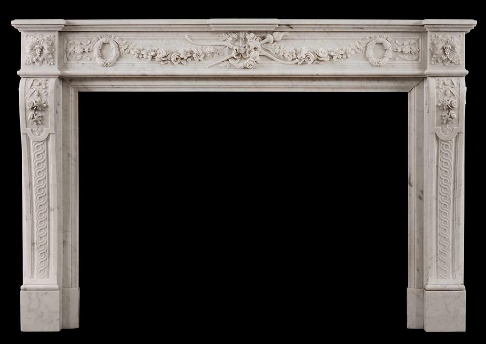 A well carved Louis XVI style French antique fireplace