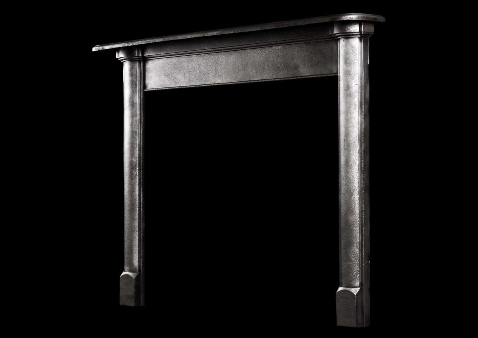 A simple polished cast iron fireplace